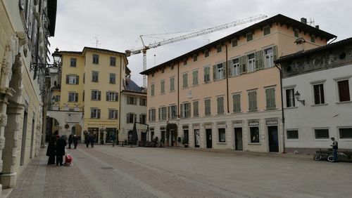 View of residential buildings in city against sky