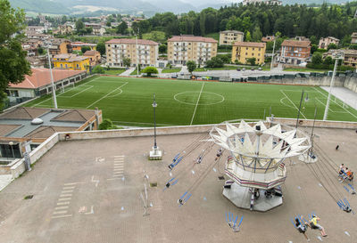 High angle view of carousel by soccer field in city