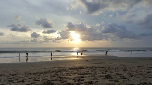 Scenic view of beach against sky during sunset