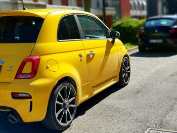 Yellow car parked on road