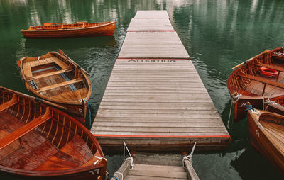 Boats moored at pier in lake