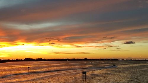 Scenic view of beach against sky during sunset