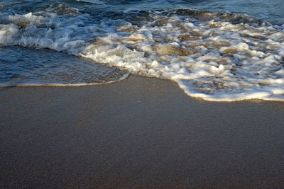 High angle view of waves rushing towards shore