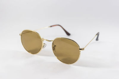 Close-up of sunglasses against white background