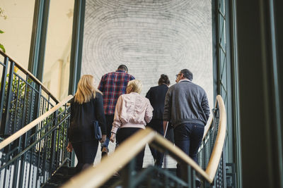 Rear view of business people moving upstairs in office