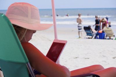 People relaxing on beach