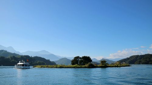 Scenic view of lake against clear blue sky