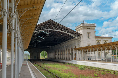 Railroad tracks amidst buildings against sky