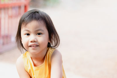Charming 4 years old cute baby asian girl, little preschooler child smiling and looking at camera.
