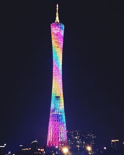 Low angle view of illuminated tower at night