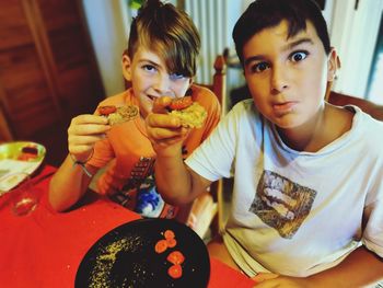 Portrait of siblings sitting on floor