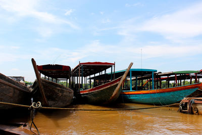 Boat moored in sea against sky