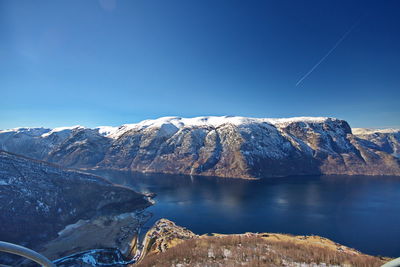 Scenic view of snowcapped mountains against clear blue sky