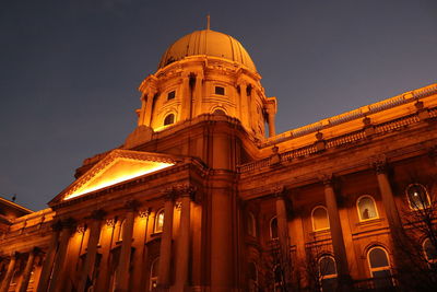 Low angle view of illuminated building against sky at night