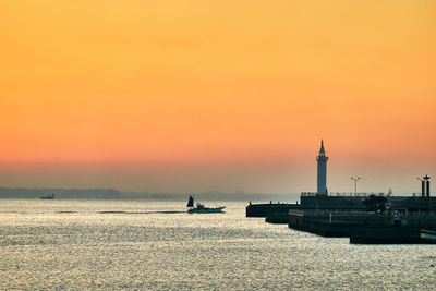 Scenic view of sea against orange sky