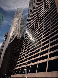 Low angle view of buildings against cloudy sky