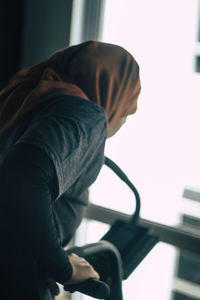 Side view of man sitting on seat