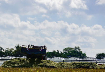 Tractor on field against sky