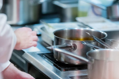 Male chief in the restaurant preparing dinner.