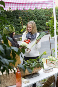 Young women looking at home-grown vegetables