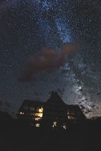 Low angle view of illuminated building against sky at night