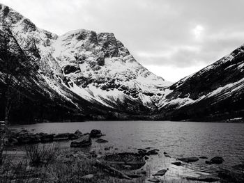 Scenic view of snowcapped mountains by lake