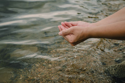 Low section of person in water at beach