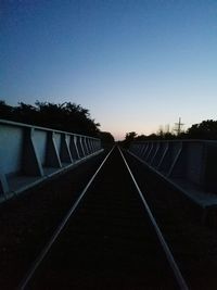 Railroad tracks against clear sky