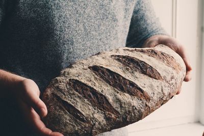 Close-up of hand holding a sourdough bread