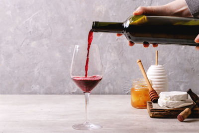 Man pouring wine in glass bottle