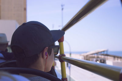 Portrait of boy in boat against sky