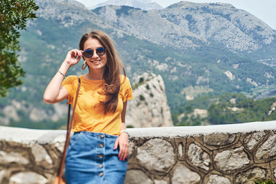 Portrait of smiling young woman in mountains