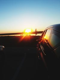 Car on road against sky during sunset