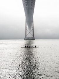 Bridge over sea against sky