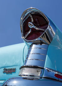 Close-up of metallic structure against blue sky