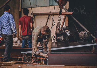 Rear view of man working at construction site