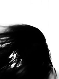 Close-up portrait of woman against white background