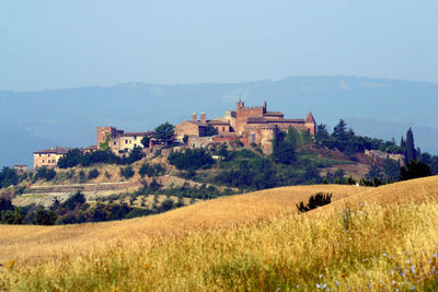 Houses on landscape against sky