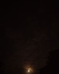 Low angle view of moon in sky at night