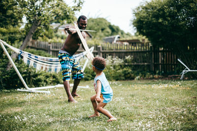 Rear view of boy with arms raised