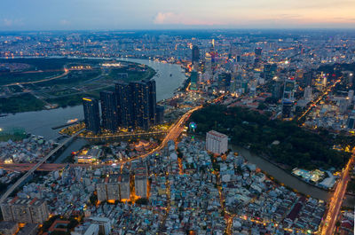 High angle view of illuminated city buildings against sky