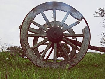 Old rusty machine on field