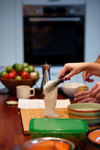 Midsection of man preparing food on table