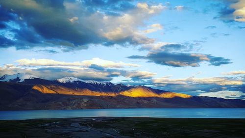 Scenic view of lake and mountains against sky