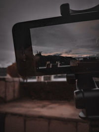 Close-up of telephone booth against sky