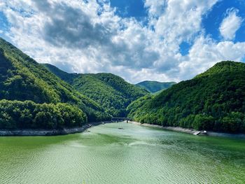 Scenic view of lake and mountains against sky