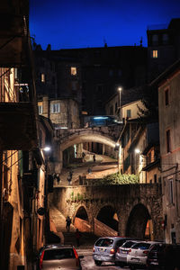 View of city street and buildings at night