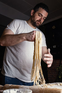 Portrait of senior man preparing food at home