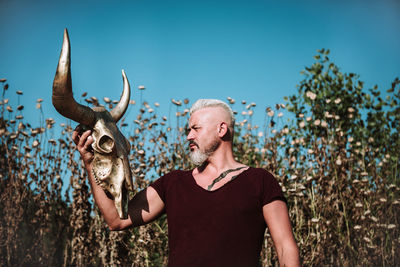 Low section of woman holding deer