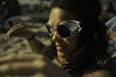 Close-up portrait of young woman wearing sunglasses